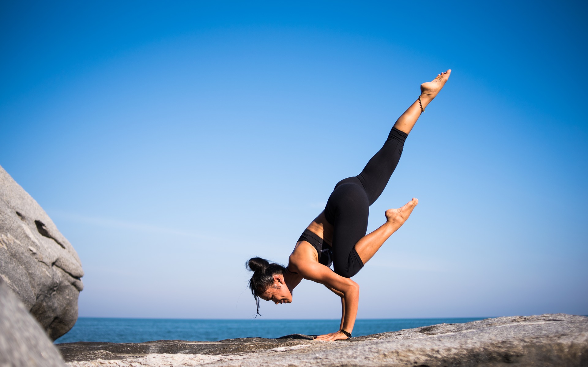 a woman doing yoga outdoors